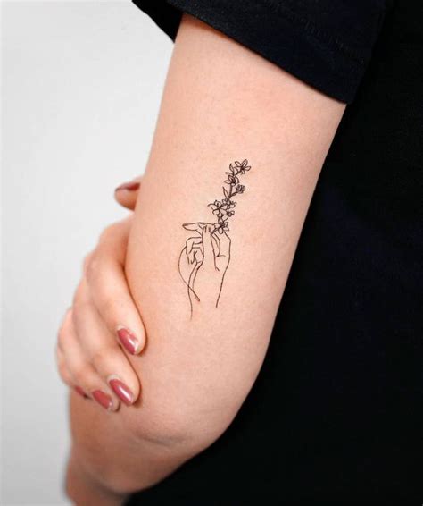 pictures of tattoos flowers|hand holding flower tattoo.